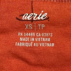 this is a orange strapless tank top from Arie it is a XS.